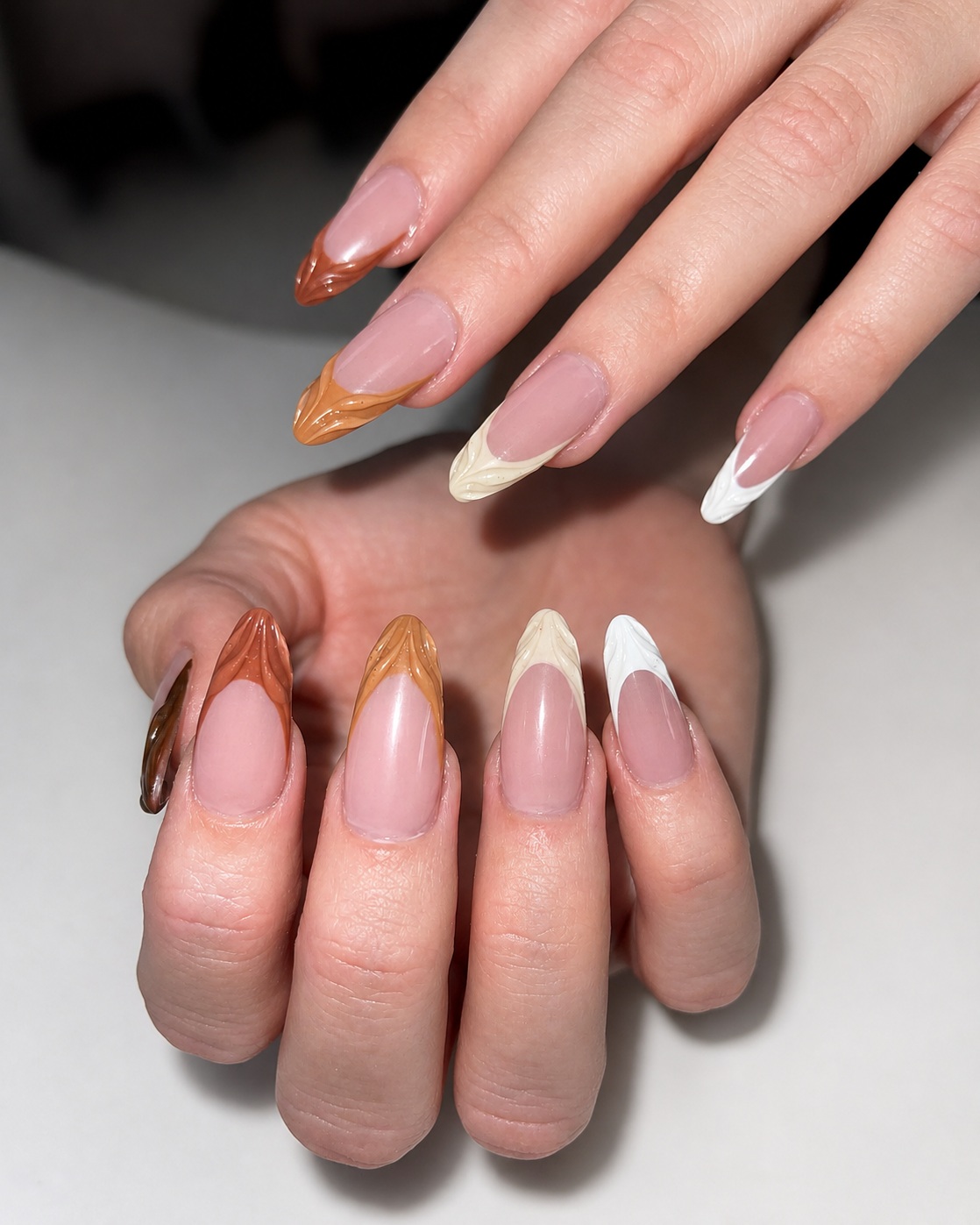 Neutral French nail design in rich caramel and cream tones