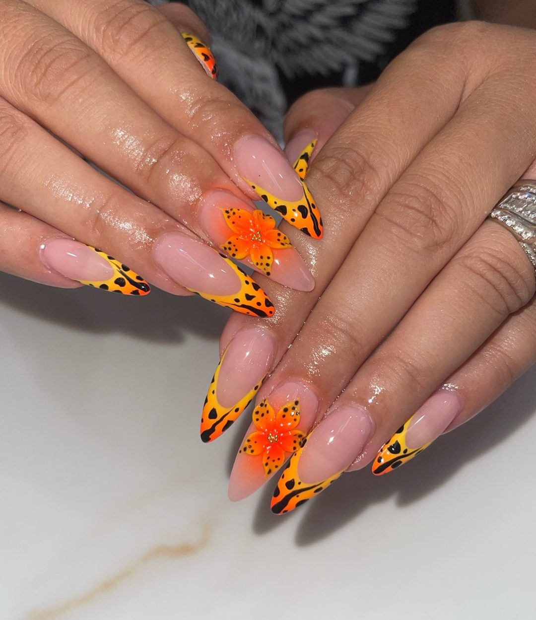 Orange and yellow artistic French manicure with floral accents