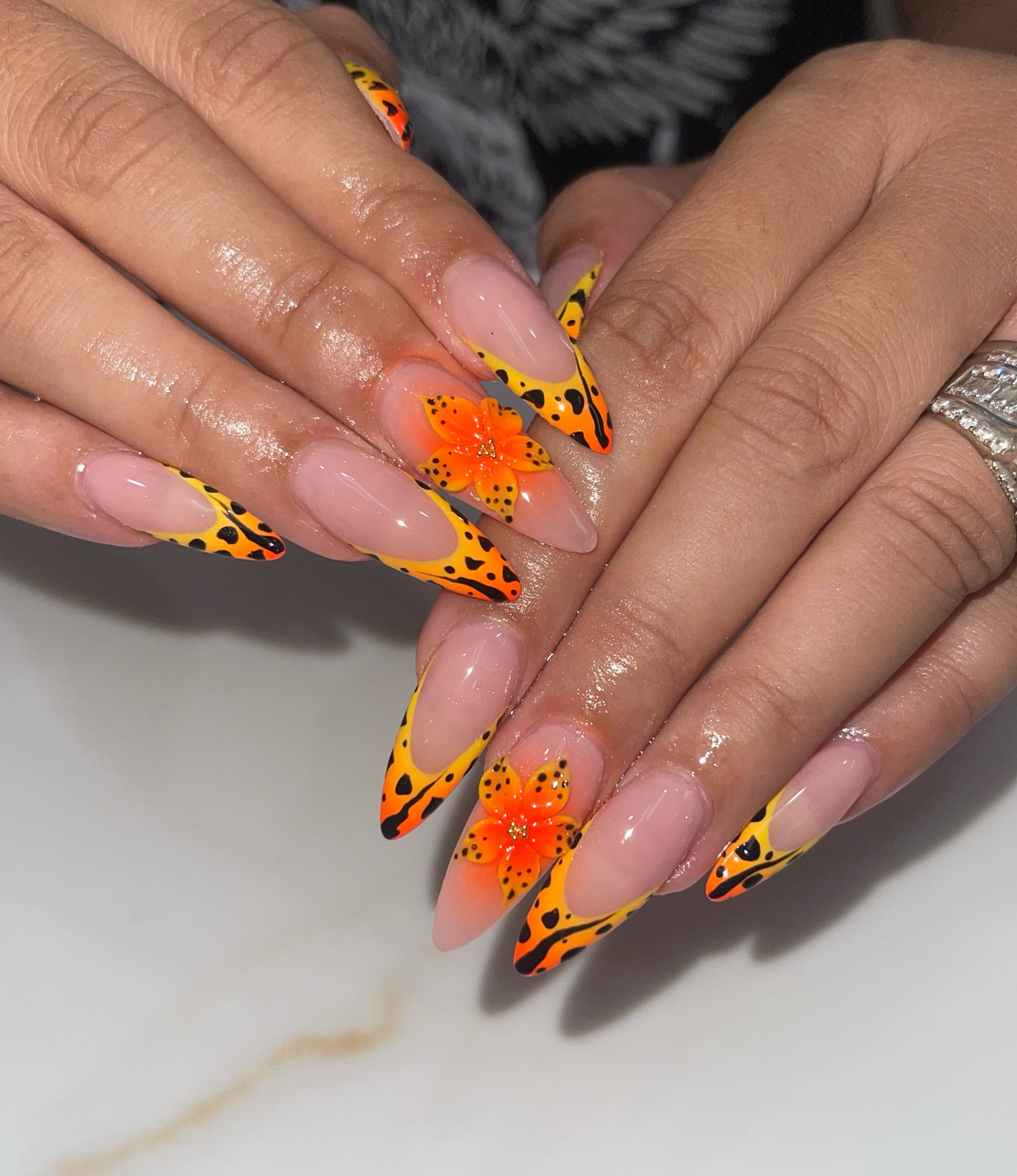 Orange and yellow artistic French manicure with floral accents