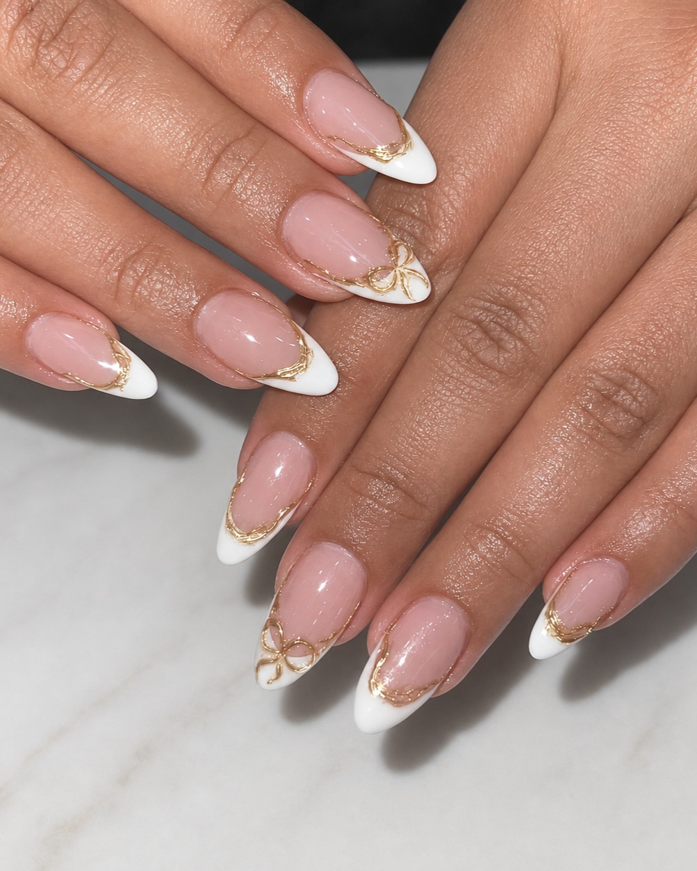 Elegant white French manicure with delicate gold accents